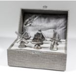 Six Dutch silvery metal bottle stoppers, four modeled as ships and two modeled as windmills,