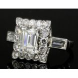 A mid 20th Century platinum mounted all diamond set ring, the central emerald cut stone of