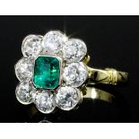A modern 18ct gold mounted emerald and diamond ring, the emerald cut stone of approximately .50ct,
