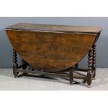 A late 17th/early 18th Century oak oval gateleg table on bobbin turned supports, 48ins x 55ins x