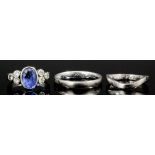 A modern 18ct white gold mounted sapphire and diamond ring, the oval cut sapphire of approximately