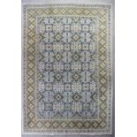 A Kashan carpet woven in pastel shades, floral and lozenge filled trellis, on an ivory ground,