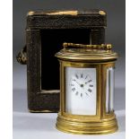 A late 19th Century French oval cased miniature carriage clock, the white enamel dial with Roman