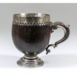 A mid-18th Century English silvery metal mounted coconut cup, the silvery metal rim engraved - "