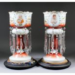 A pair of early 20th Century opaque glass lustre vases, with cut glass prismatic drops,