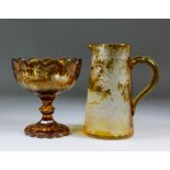 A Bohemian amber-flashed and cut glass sugar bowl on high foot, cut with a design of deer in a