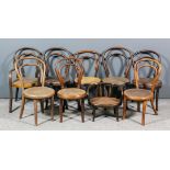 A dolls bentwood chair with caned circular seat and arms, 26ins high, and eight others with caned,