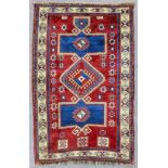 A Kazak Fakhralu rug woven in colours, the bold central medallion comprising lozenge-shaped centre