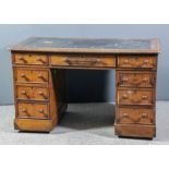 A Victorian oak kneehole desk with black leather cloth inset to top and moulded edge to top,