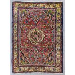 A Persian Tafresh rug woven in colours with a bold central medallion and conforming spandrels, field