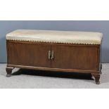 A mahogany box Ottoman/cellaret, the lifting lid upholstered in cream leather and studded, now