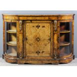 A Victorian figured walnut and gilt metal mounted break front credenza inlaid with stringings and