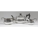 An Edward VII silver rectangular three-piece tea service with moulded rim, raised band to bodies,