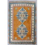 A modern Turkish rug woven in pastel colours with two central star pattern medallions, on a plain