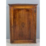 An 18th Century oak hanging corner cupboard with dentil cornice, fitted three shelves enclosed by