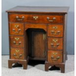 A lady's walnut kneehole dressing table in the "Georgian" style, the whole inlaid with stringings,