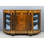 A late Victorian rosewood and gilt metal mounted credenza with curved ends, the frieze inlaid with