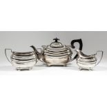 A George V silver rectangular three piece tea service with gadroon mounts, bulbous bodies, angular
