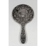 An Elizabeth II silver backed dressing table mirror embossed with a vacant cartouche, masks, birds