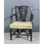 A George III mahogany open armchair of "Chippendale" design, with shaped crest rail, fretted vase