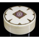 An early 19th Century Continental ivory and gold metal mounted circular pattern snuff box, the lid