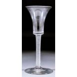 An 18th Century wine glass with plain bell-shaped bowl and fine air twist stem, on plain foot with