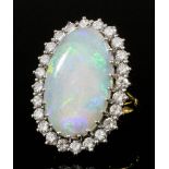 A modern gold coloured metal mounted opal and diamond ring, the oval cut opal 25mm x 15mm overall,