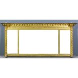 A Regency gilt overmantel mirror, the overhanging cornice with ball ornament, above reeded frieze,