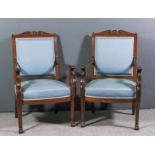 A pair of late 19th Century French mahogany framed armchairs in the "Empire" style, with shaped