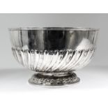 A late Victorian silver Regimental circular punch bowl with moulded rim, part reeded and fluted