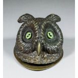 A late 19th Century French bronze stamp box in the form of an owls head with glass eyes, 4.5ins long