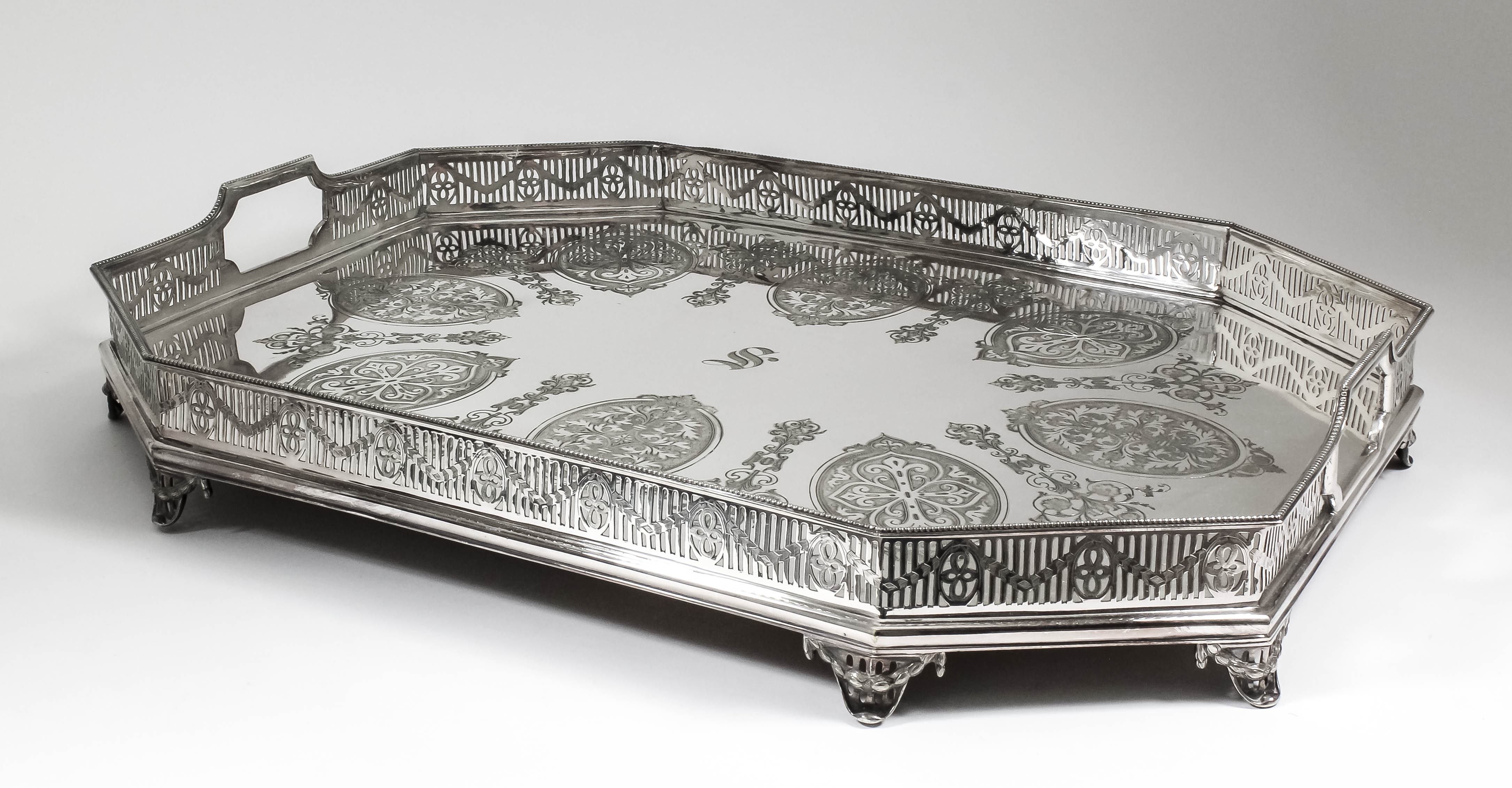 A plated octagonal galleried two-handled tray of Neo-classical design, with bead mounts, pierced