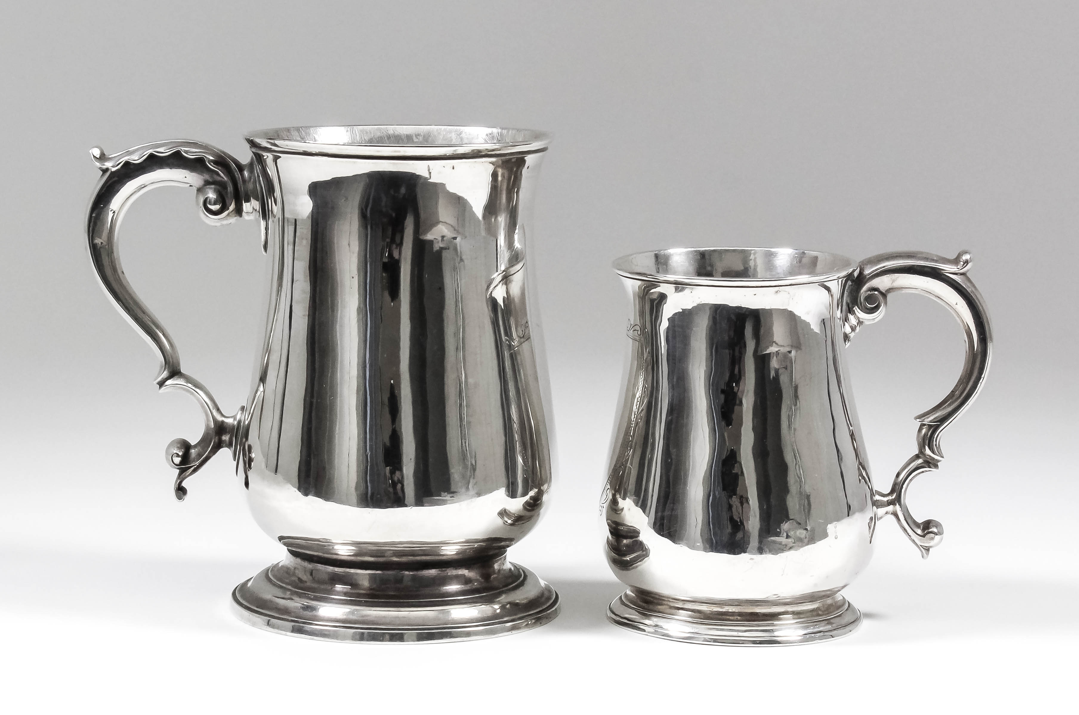 A George III silver baluster-shaped mug with moulded rim and footrim and with leaf capped double