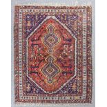A North West Persian rug woven in colours with two central pole medallions and stylized floral and