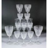 An early 20th Century part cut glass table service, comprising - twelve wine glasses, 7ins high, six