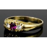 An 18ct gold mounted ruby and diamond three stone dress ring in the "Victorian" manner, set with