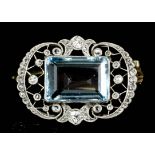 A 1920s silvery coloured metal mounted aquamarine and diamond set brooch, the emerald cut aquamarine