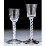 An 18th Century wine glass with small ribbed bowl and white opaque double twist stem, on plain foot,