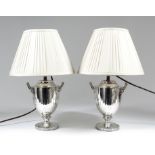 A pair of late Victorian silver two-handled urn pattern table oil lamps (now converted to