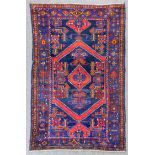 A Persian Brojerd rug woven in colours, the bold central octagonal medallion filled with geometric