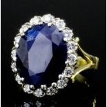 A modern 18ct gold mounted sapphire and diamond ring, the oval cut sapphire of approximately 3ct, in