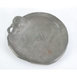 ART NOUVEAU EMBOSSED PEWTER SHALLOW CIRCULAR DISH, design of a girl holding a tail bird, her flowing