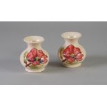 PAIR OF MODERN MOORCROFT MAGNOLIA PATTERN TUBE LINED POTTERY VASES of squat form with waisted necks,