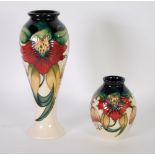 TWO MODERN MOORCROFT 'ANNA LILY' PATTERN TUBE LINED POTTERY VASES, one of slender baluster form, 11"