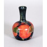 WALTER MOORCROFT POMEGRANATE PATTERN TUBE LINED SMALL POTTERY VASE, of globe and shaft form, 4" (