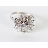 DIAMOND CLUSTER RING, centre set with a round brilliant cut diamond, 0.75ct approx., with a surround