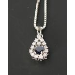 SAPPHIRE AND DIAMOND SET 18CT WHITE GOLD PENDANT, round cut sapphire with drop shaped surround of 14
