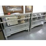 *A PAIR OF SILVERED FINISH CHESTS OF THREE LONG DRAWERS, THE TOPS EACH WITH BEVELLED MIRROR GLASS