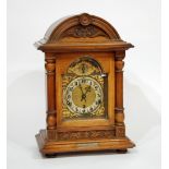 EARLY TWENTIETH CENTURY CARVED OAK MANTEL CLOCK, the Arabic dial with gilt spandrels and silent/