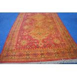 EASTERN CARPET, principally crimson and gold with large pole medallion pattern in gold on a